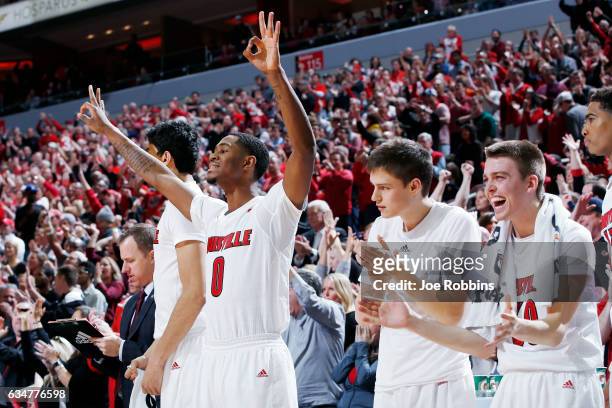 King, David Levitch and Ryan McMahon of the Louisville Cardinals react from the bench in the second half of the game against the Miami Hurricanes at...