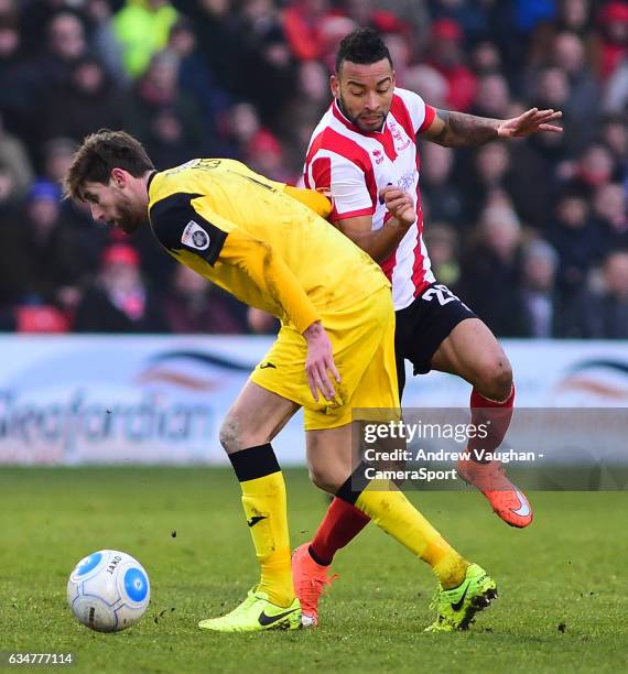 Lincoln City's Nathan Arnold vies for possession with Woking's Joe Jones during the Vanarama National League match between Lincoln City and Woking at...