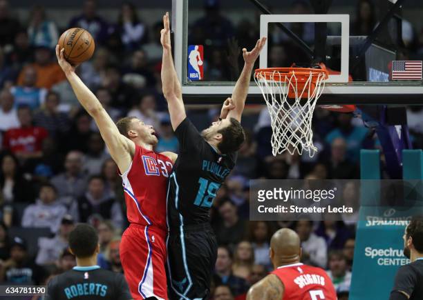 Blake Griffin of the LA Clippers dunks the ball over Miles Plumlee of the Charlotte Hornets during their game at Spectrum Center on February 11, 2017...