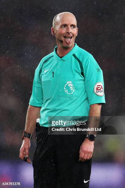 Referee Mike Dean gestures during the Premier League match between Middlesbrough and Everton at Riverside Stadium on February 11, 2017 in...