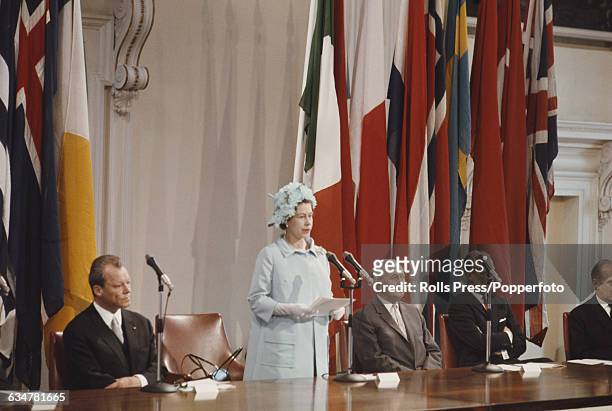 Queen Elizabeth II of the United Kingdom addresses a 20th anniversary meeting of the Council of Europe from a dias inside the Banqueting House in...