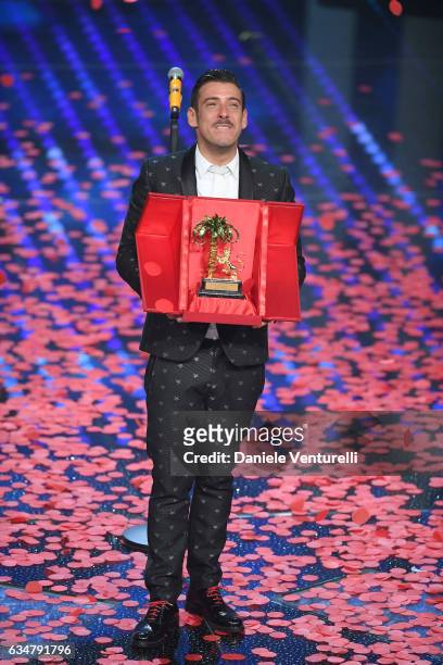 Italian singer Francesco Gabbani , winner of the 67th Italian Music Festival in Sanremo, pose with the award at Teatro Ariston on February 11, 2017...