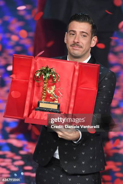 Italian singer Francesco Gabbani , winner of the 67th Italian Music Festival in Sanremo, pose with the award at Teatro Ariston on February 11, 2017...