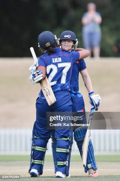 Katie Perkins of the Hearts is congratulated by Regina Lilii of the Hearts after scoring her century during the Women's One Day Final match between...