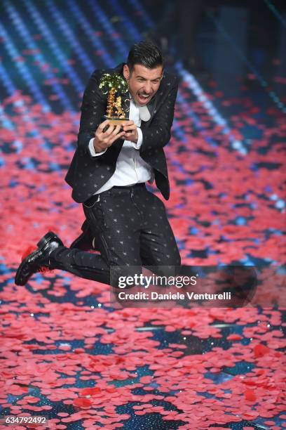 Italian singer Francesco Gabbani , winner of the 67th Italian Music Festival in Sanremo, pose with the award at Teatro Ariston on February 11, 2017...