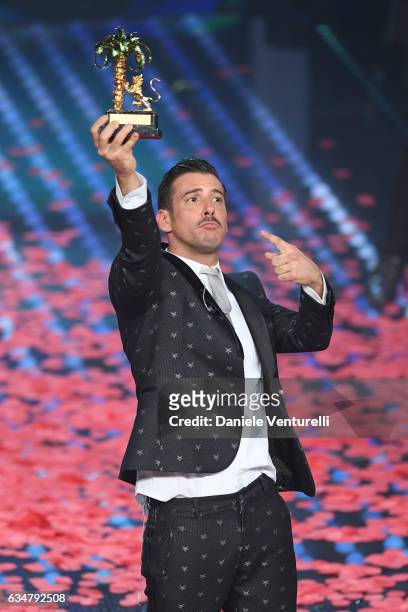 Italian singer Francesco Gabbani , winner of the 67th Italian Music Festival in Sanremo, pose with the award at Teatro Ariston on February 11, 2017...
