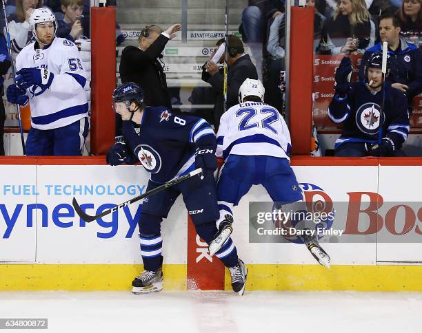 Jacob Trouba of the Winnipeg Jets eludes a check from Erik Condra of the Tampa Bay Lightning along the boards during second period action at the MTS...