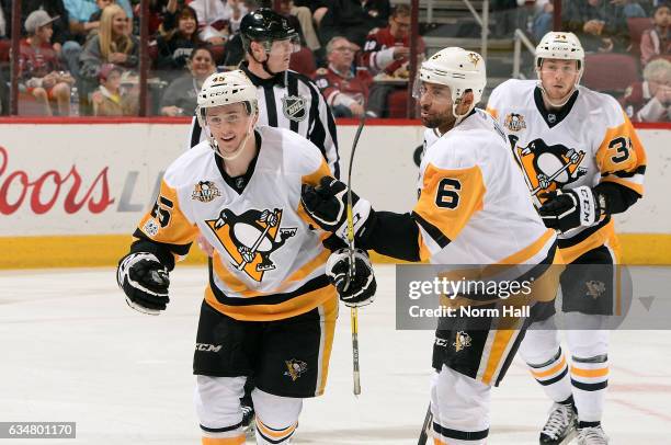 Josh Archibald of the Pittsburgh Penguins is congratulated by teammate Trevor Daley as he skates off the ice after scoring his first career NHL goal...