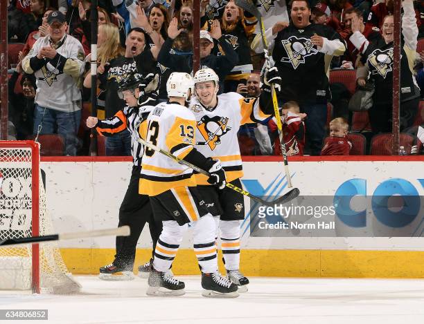 Josh Archibald of the Pittsburgh Penguins is congratulated by teammate Nick Bonino after scoring a third period goal against the Arizona Coyotes at...