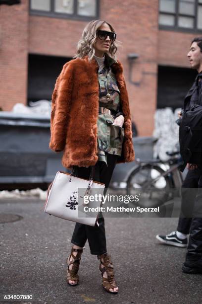 Olivia Barr is seen attending TIBI during New York Fashion Week wearing a golden brown fur coat with camo top on February 11, 2017 in New York City.
