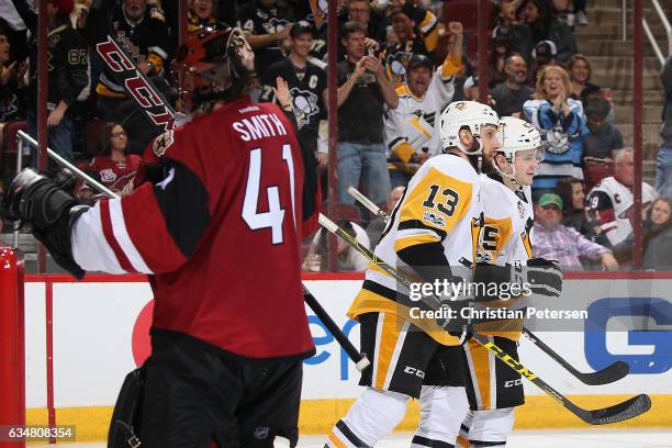 Josh Archibald of the Pittsburgh Penguins is congratulated by Nick Bonino after scoring a shorthanded goal past goaltender Mike Smith of the Arizona...