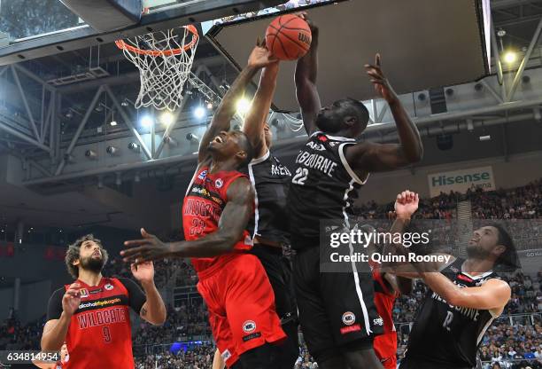 Majok Majok of United blocks a shot by Casey Prather of the Wildcatsduring the round 19 NBL match between Melbourne United and the Perth Wildcats at...