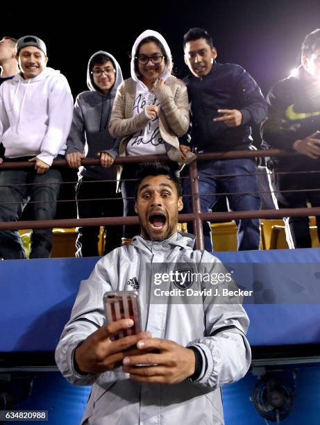 Chris Wondolowski of San Jose Earthquakes takes a selfie with fans after defeating the Los Angeles Galaxy 1-0 during the California Clasico game at...