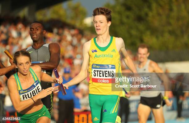 Luke Stevens of Australia passes the baton to Anneliese Rubie of Australia as they compete in the Mixed 2000 Sprint Medley race during the Melbourne...
