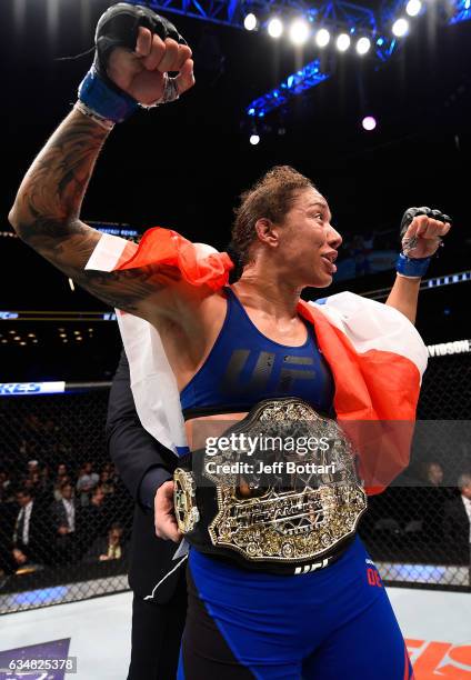 Germaine de Randamie of The Netherlands celebrates her victory over Holly Holm in their women's featherweight championship bout during the UFC 208...