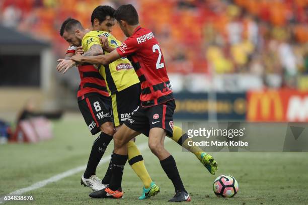Roy O'Donovan of the Mariners is tackled by Dimas and Jonathan Aspropotamitis of the Wanderers during the round 19 A-League match between the Western...