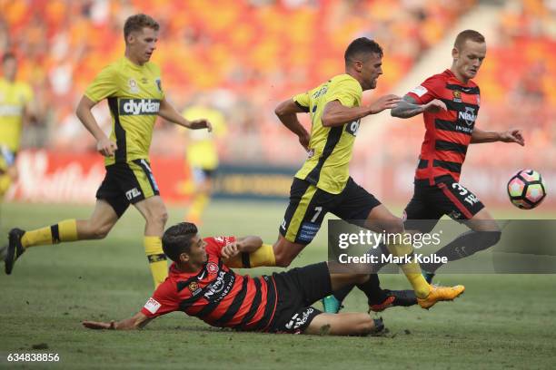 Fabio Ferreira of the Mariners is tackled by Jonathan Aspropotamitis of the Wanderers during the round 19 A-League match between the Western Sydney...