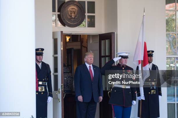 President Donald Trump awaits the arrival of Japanese Prime Minster Shinz Abe in front of the West Wing of the White House in Washington, DC on...