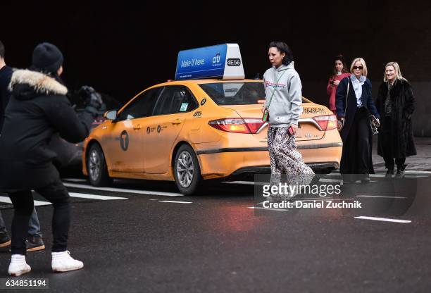 Jeannie Lee is seen wearing a Champion gray sweatshirt and graphic skirt at the Dion Lee show during New York Fashion Week: Women's Fall/Winter 2017...