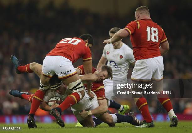 Matt Mullan of England is tackled by Dan Biggar and Toby Faletau of Wales during the RBS Six Nations match between Wales and England at the...