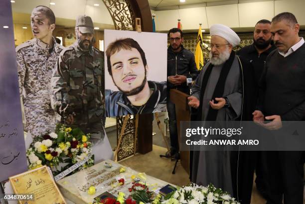 Lebanese Sunni cleric Sheikh Maher Hammud recites the Fatiha, or the prayer of the dead, during his visit to the tombs of slain Hezbollah commanders...