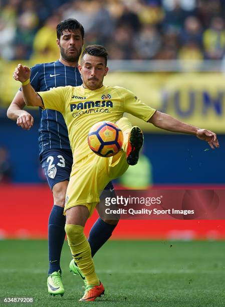 Nicola Sansone of Villarreal competes for the ball with Miguel Torres of Malaga during the La Liga match between Villarreal CF and Malaga CF at...