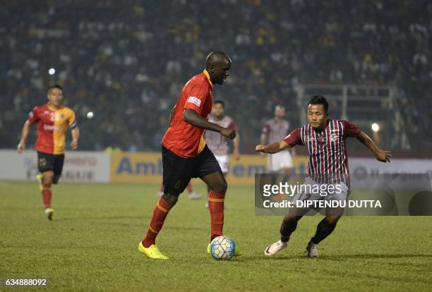 East Bengal's Ivan Bukenya controls the ball past Mohun Bagan's Jeje Lalpekhlua during an Indian I-League football match between Mohun Bagan and East...