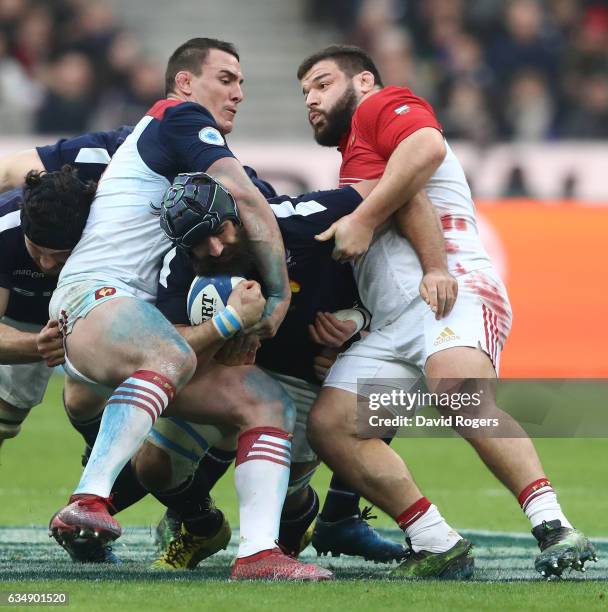 Josh Strauss of Scotland is wrapped up by Louis Picamoles and Rabah Slimani of France during the RBS Six Nations match between France and Scotland at...