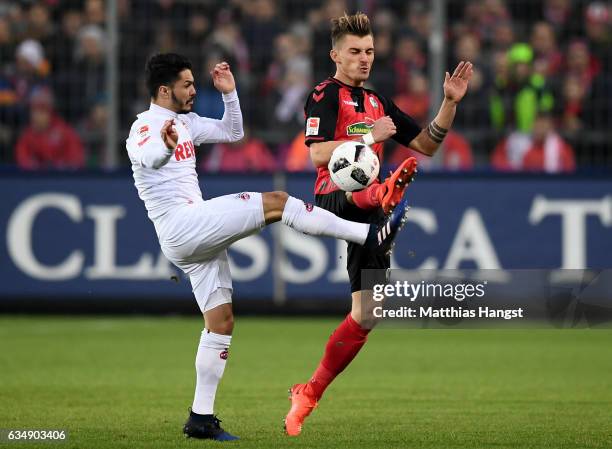 Leonardo Bittencourt of Koeln is challenged by Maximilian Philipp of Freiburg during the Bundesliga match between SC Freiburg and 1. FC Koeln at...