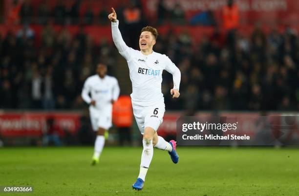 Alfie Mawson of Swansea City celebrates as he scores their first goal during the Premier League match between Swansea City and Leicester City at...