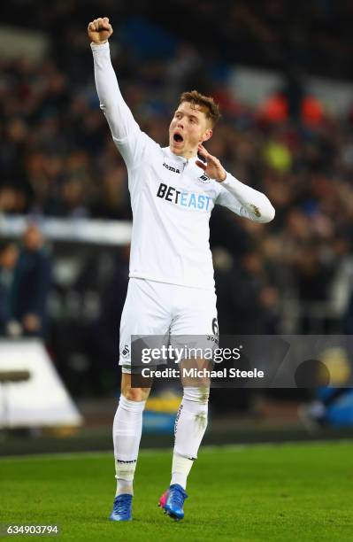 Alfie Mawson of Swansea City celebrates as he scores their first goal during the Premier League match between Swansea City and Leicester City at...