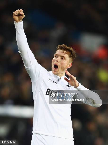 Alfie Mawson of Swansea City celebrates as he scores their first goal during the Premier League match between Swansea City and Leicester City at...