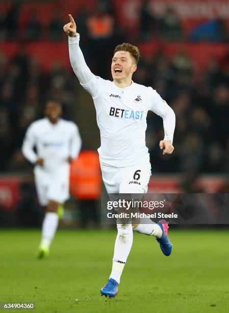 Alfie Mawson of Swansea City celebrates as he scores their first goal during the Premier League match between Swansea City and Leicester City at...