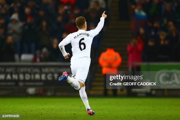 Swansea City's English defender Alfie Mawson celebrates after scoring the opening goal of the English Premier League football match between Swansea...