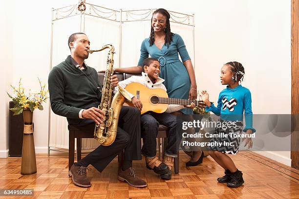 family at home playing music - sister act stock pictures, royalty-free photos & images