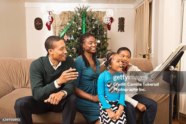 family singing at home - camille singer stock pictures, royalty-free photos & images