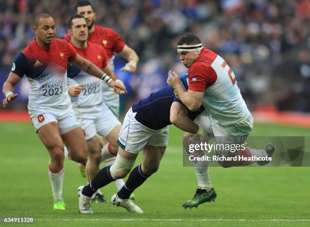 Guilhem Guirado of France is tackled by Alex Dunbar of Scotland during the RBS Six Nations match between France and Scotland at Stade de France on...