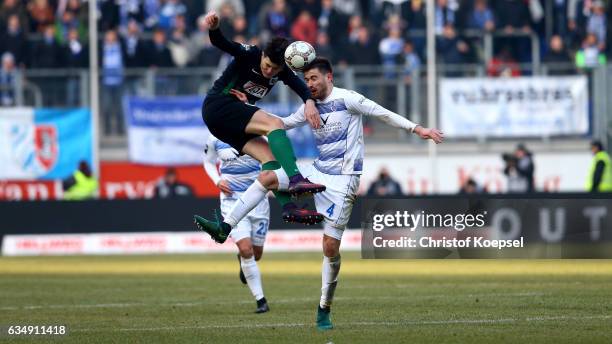 Tobias Warschewski of Muenster and Dustin Bomheuer of Duisburg go up for a header during the Third League match between MSV Duisburg and Preussen...