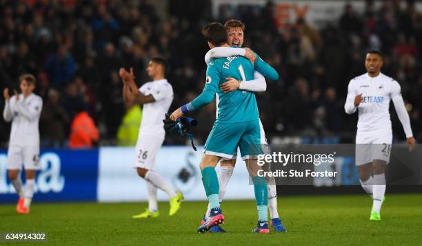 Lukasz Fabianski and Alfie Mawson of Swansea City celebrate victory with team mates during the Premier League match between Swansea City and...