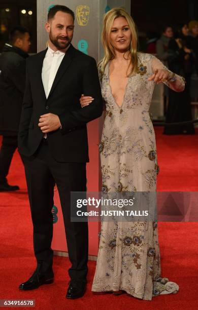 Actress Julia Stiles and Preston J Cook pose upon arrival at the BAFTA British Academy Film Awards at the Royal Albert Hall in London on February 12,...
