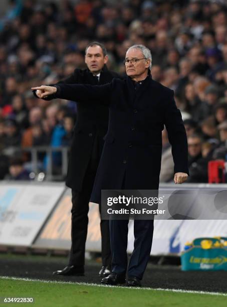 Paul Clement manager of Swansea City and Claudio Ranieri manager of Leicester City signal from the touchline during the Premier League match between...