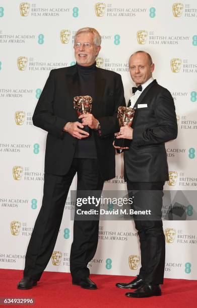 Roy Helland and Daniel Phillips, winners of the Hair and Makeup award for "Florence Foster Jenkins", pose in the winners room at the 70th EE British...