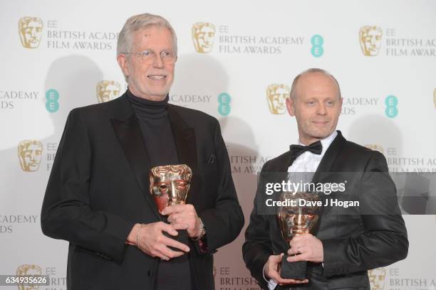 Roy Helland and Daniel Phillips pose with their awards for Hair and Makeup in the film 'Florence Foster Jenkins' in the winners room at the 70th EE...