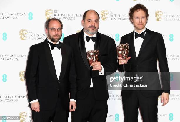 Films Not In The English Language winners Gabor Sipos, Gabor Rajna and Laszlo Nemes pose with their awards in the winners room during the 70th EE...