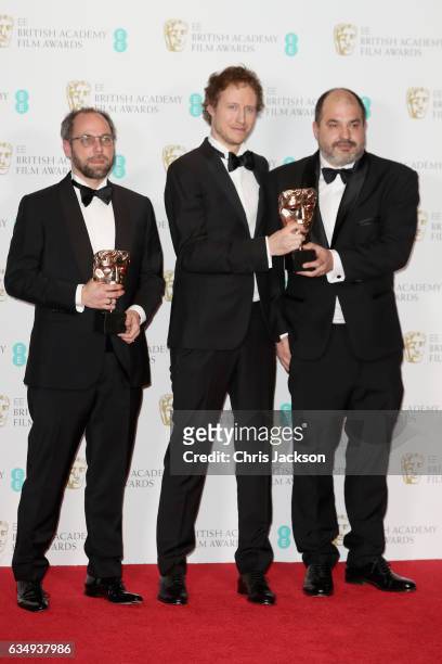 Films Not In The English Language winners Gabor Sipos, Laszlo Nemes and Gabor Rajna pose with their awards in the winners room during the 70th EE...