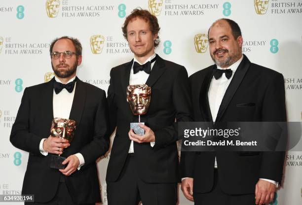 Gabor Sipos, Laszlo Nemes and Gabor Rajna, winners of the Film Not In The Engliash Language award for "Son Of Saul", poses in the winners room at the...