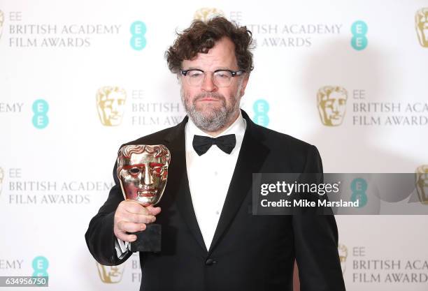 Kenneth Lonergan, winner of the Original Screenplay award for 'Manchester By The Sea', poses in the winners room at the 70th EE British Academy Film...