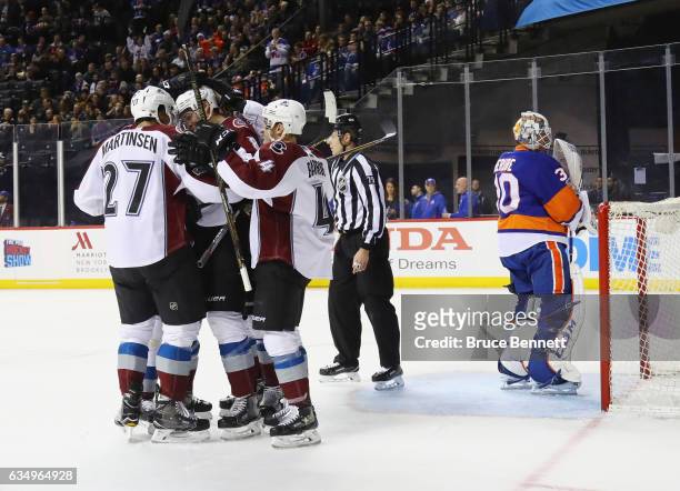 The Colorado Avalanche celebrate a first period goal by Joe Colborne against Jean-Francois Berube of the New York Islanders at the Barclays Center on...