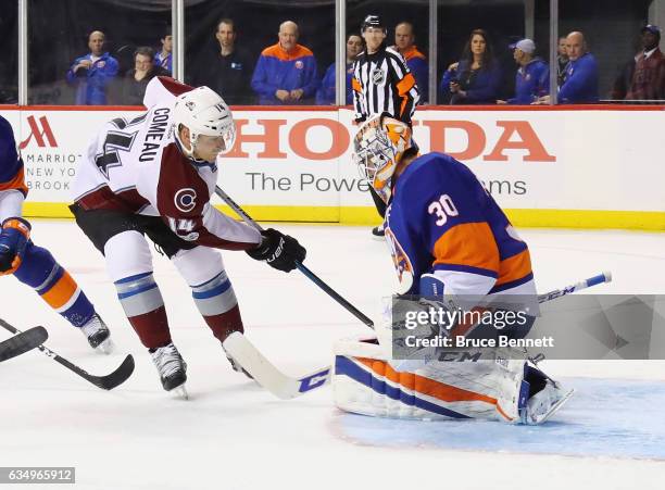 Jean-Francois Berube of the New York Islanders makes the first period stop on Blake Comeau of the Colorado Avalanche at the Barclays Center on...