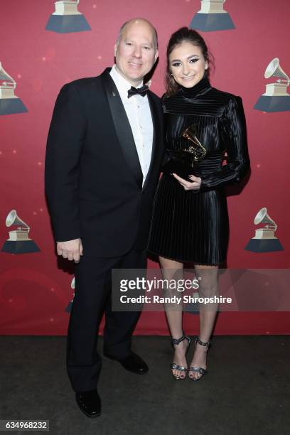 The Recording Academy's chairman of the board John Poppo and singer Daya poses with the Best Dance Recording award for 'Don't Let Me Down' backstage...